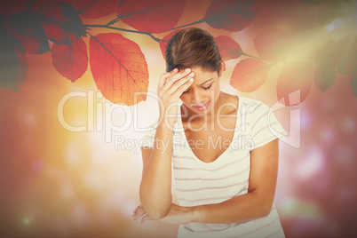Composite image of a pretty brunette with headache