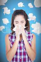 Composite image of beautiful woman sneezing in a tissue