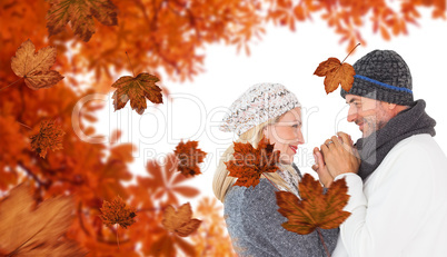 Composite image of cute smiling couple holding hands