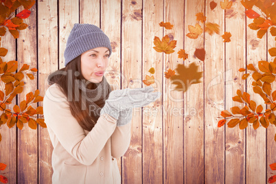 Composite image of beautiful brunette blowing kiss