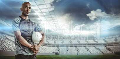 Composite image of portrait of confident sportsman with rugby ball
