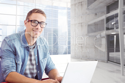 Composite image of hipster on laptop