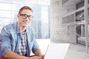 Composite image of hipster on laptop