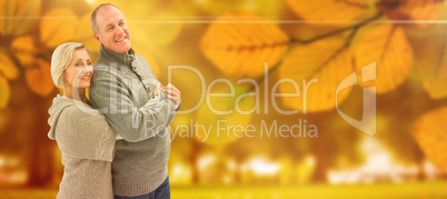 Composite image of happy mature couple in winter clothes