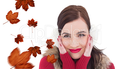 Composite image of brunette in winter clothes smiling at camera