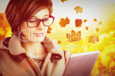 Composite image of beautiful woman in glasses using tablet compu