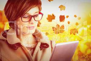 Composite image of beautiful woman in glasses using tablet compu