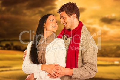 Composite image of young couple smiling and hugging