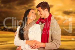 Composite image of young couple smiling and hugging