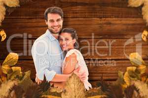 Composite image of attractive young couple hugging and smiling a