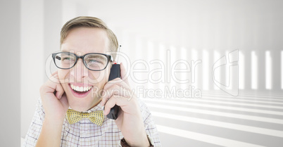 Composite image of geeky hipster holding a retro cellphone