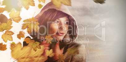 Composite image of beautiful woman wearing winter coat looking a