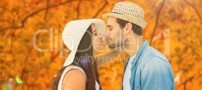 Composite image of happy hipster couple about to kiss