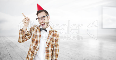 Composite image of geeky hipster in party hat pointing