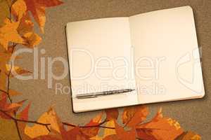 Composite image of notebook and pen