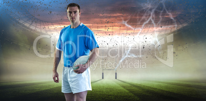 Composite image of rugby player holding a rugby ball