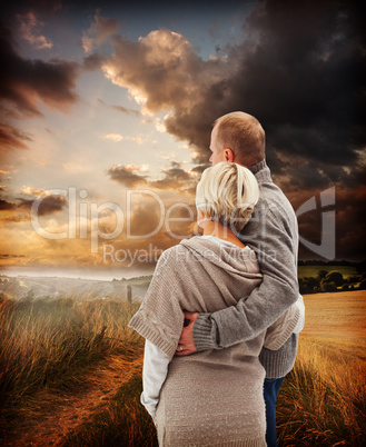 Composite image of happy mature couple in winter clothes