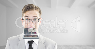 Composite image of geeky smiling businessman biting calculator