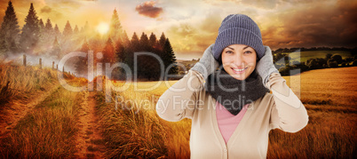 Composite image of smiling brunette wearing warm clothes