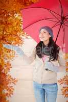 Composite image of smiling brunette feeling the rain