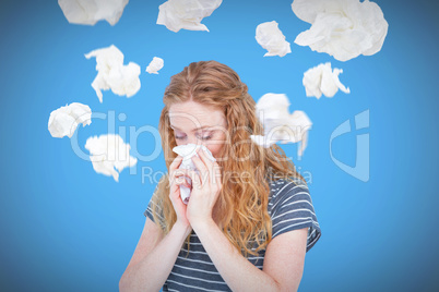 Composite image of sick blonde woman blowing her nose