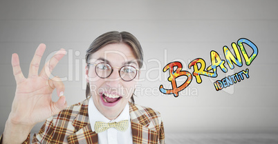 Composite image of geeky hipster doing the ok sign