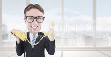 Composite image of geeky businessman holding phone