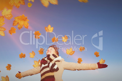 Composite image of smiling woman in winter clothes standing arms