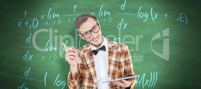 Composite image of geeky hipster holding a tablet pc
