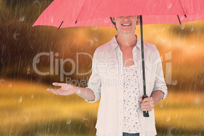 Composite image of woman holding an umbrella