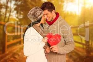 Composite image of young couple smiling and hugging