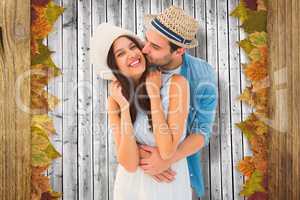 Composite image of happy hipster couple hugging and smiling