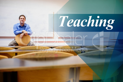 Teaching against male teacher sitting on chair in lecture hall