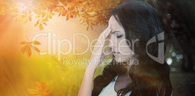 Composite image of pretty brunette getting a headache