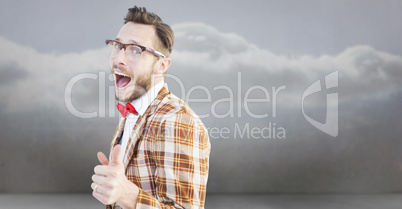 Composite image of geeky hipster pointing at camera