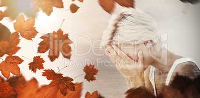 Composite image of sad blonde woman crying with head on hands