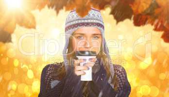 Composite image of beautiful woman in warm clothing drinking cof