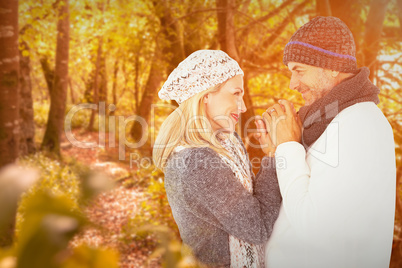 Composite image of cute smiling couple holding hands