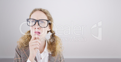 Composite image of geeky hipster woman thinking with hand on chi