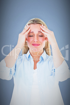 Composite image of portrait of a blonde getting a headache