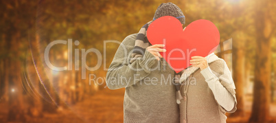 Composite image of happy mature couple in winter clothes holding