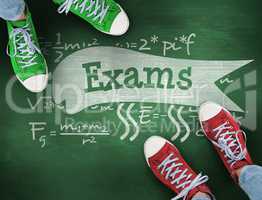 Exams against green chalkboard