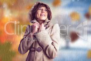 Composite image of smiling beautiful woman in winter coat lookin