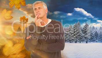 Composite image of casual man thinking with hand on chin