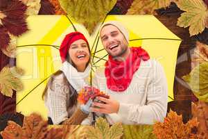 Composite image of autumn couple holding umbrella
