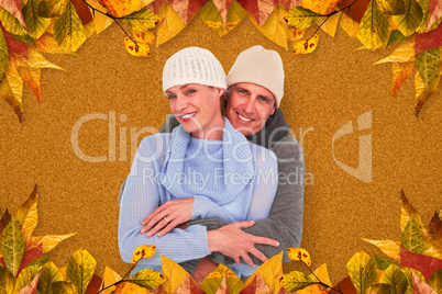 Composite image of casual couple in warm clothing