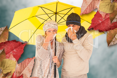 Composite image of couple sneezing in tissue while standing unde