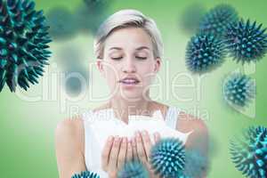 Composite image of sick woman holding tissues