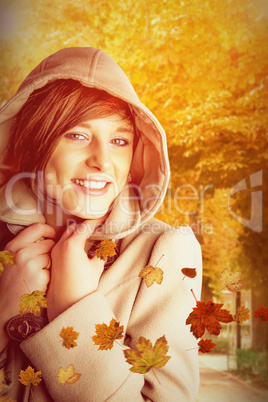 Composite image of portrait of smiling woman wearing winter coat