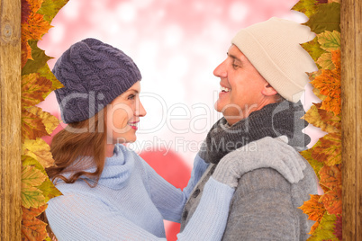 Composite image of happy couple in warm clothing